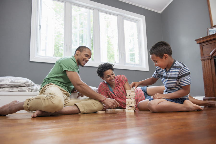 Happy family playing a game together on the floor