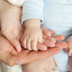 Introduce Educational Toys to Your Baby - Mom and Dad hold baby's hand