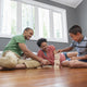 Happy family playing a game together on the floor