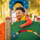 Adorable little 1-2 year old toddler boy having fun on playground