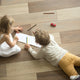 Kids sister and brother playing drawing together on wooden warm floor in living room