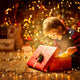 A child opening a presnt on Christmas morning.